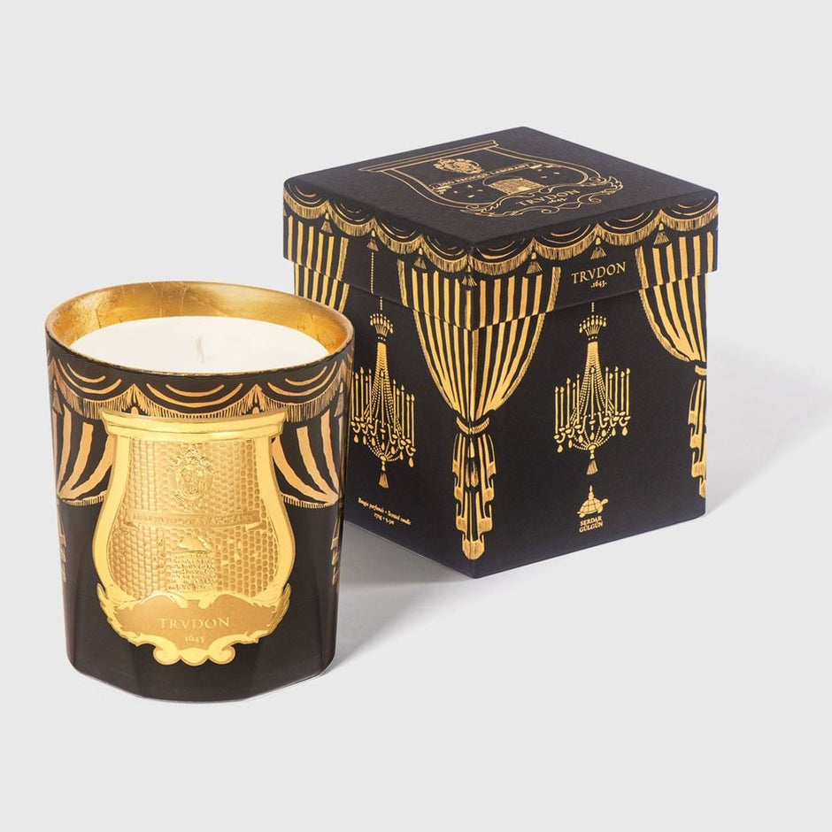 Trudon Holiday Scented Candle with orange and cinnamon aroma in a decorative glass holder