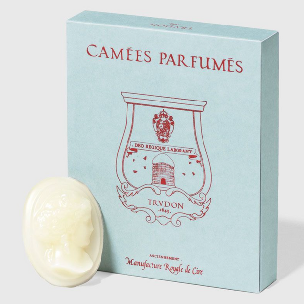 Set of four Trudon scented candles with elegant Cameos design, showcasing intricate wax details and classic candle holders.