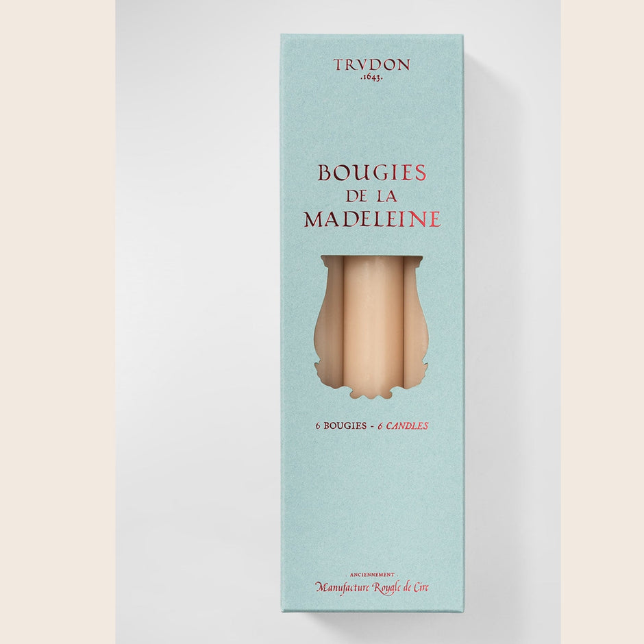 Six Trudon Madeleine taper candles in aqua, arranged in a box, featuring elegant, slender candle design for decorative lighting.