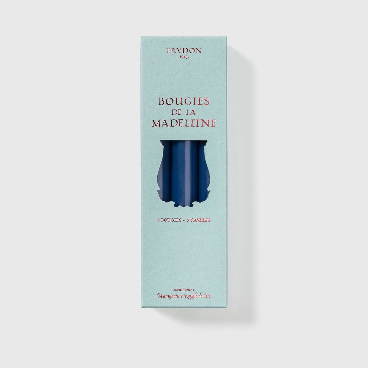 Six Trudon Madeleine taper candles in aqua, elegant candle display in a box, ideal for decorative and ambient lighting.