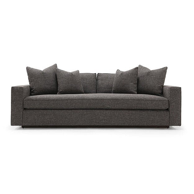 A dark green Verellen Gregoire sofa with a sleek, modern design featuring multiple cushions on a wooden frame, positioned against a white background.