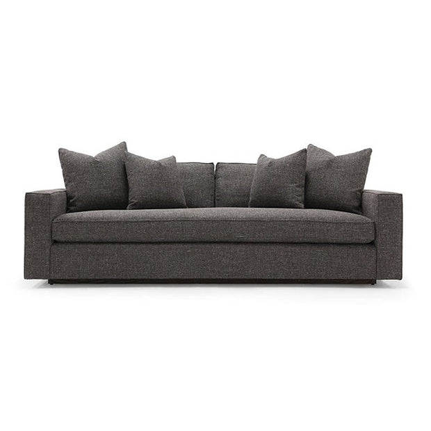A dark green Verellen Gregoire sofa with a sleek, modern design featuring multiple cushions on a wooden frame, positioned against a white background.