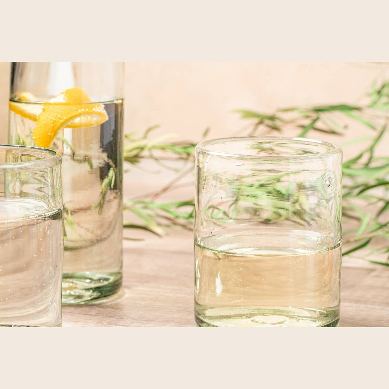 Handblown Mexican glassware by Verve Culture, clear glass drinking glasses with intricate craftsmanship and smooth finish.