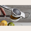 Verve Culture Mexican hand citrus juicer with wooden handle and metal reamer for fresh juice extraction.
