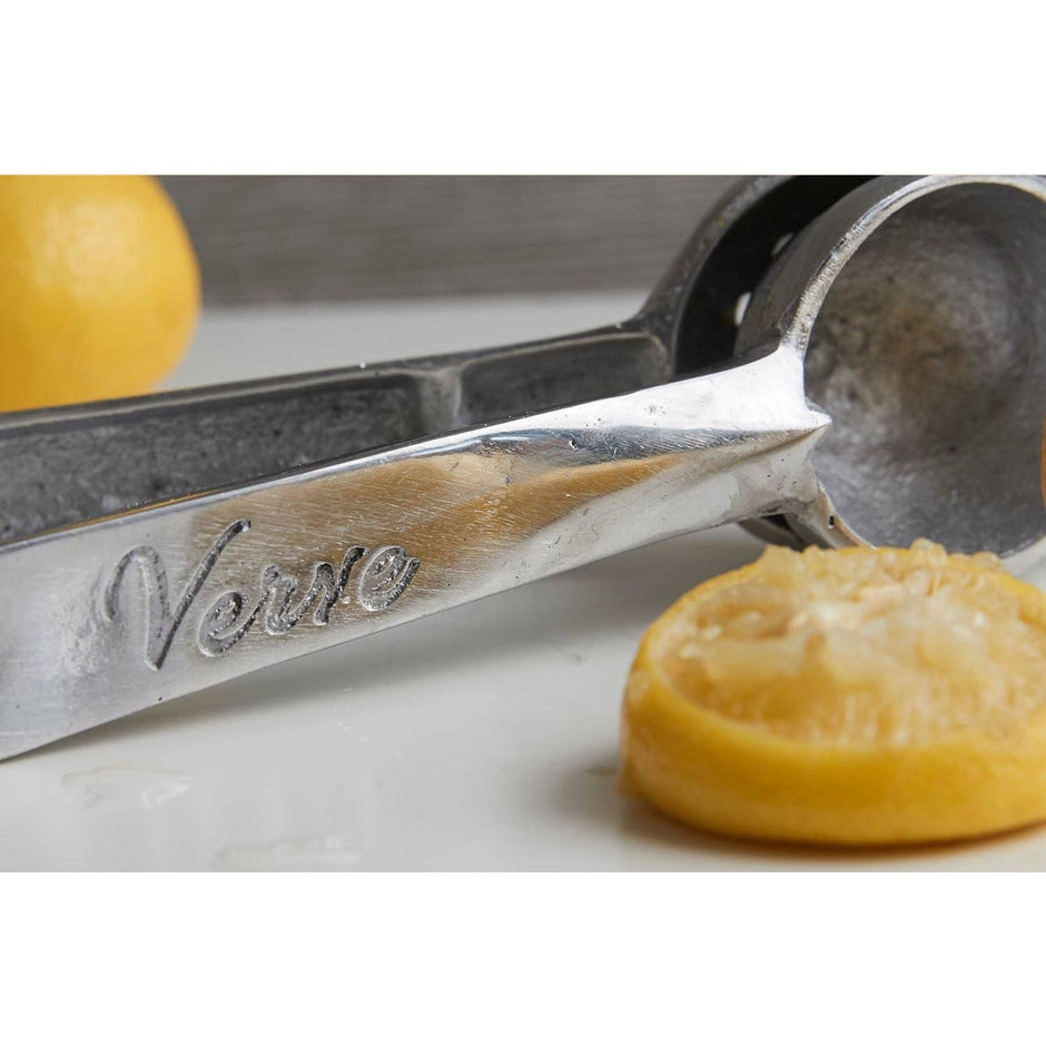 Mexican hand citrus juicer by Verve Culture with wooden handle and metal reamer for fresh juice extraction.