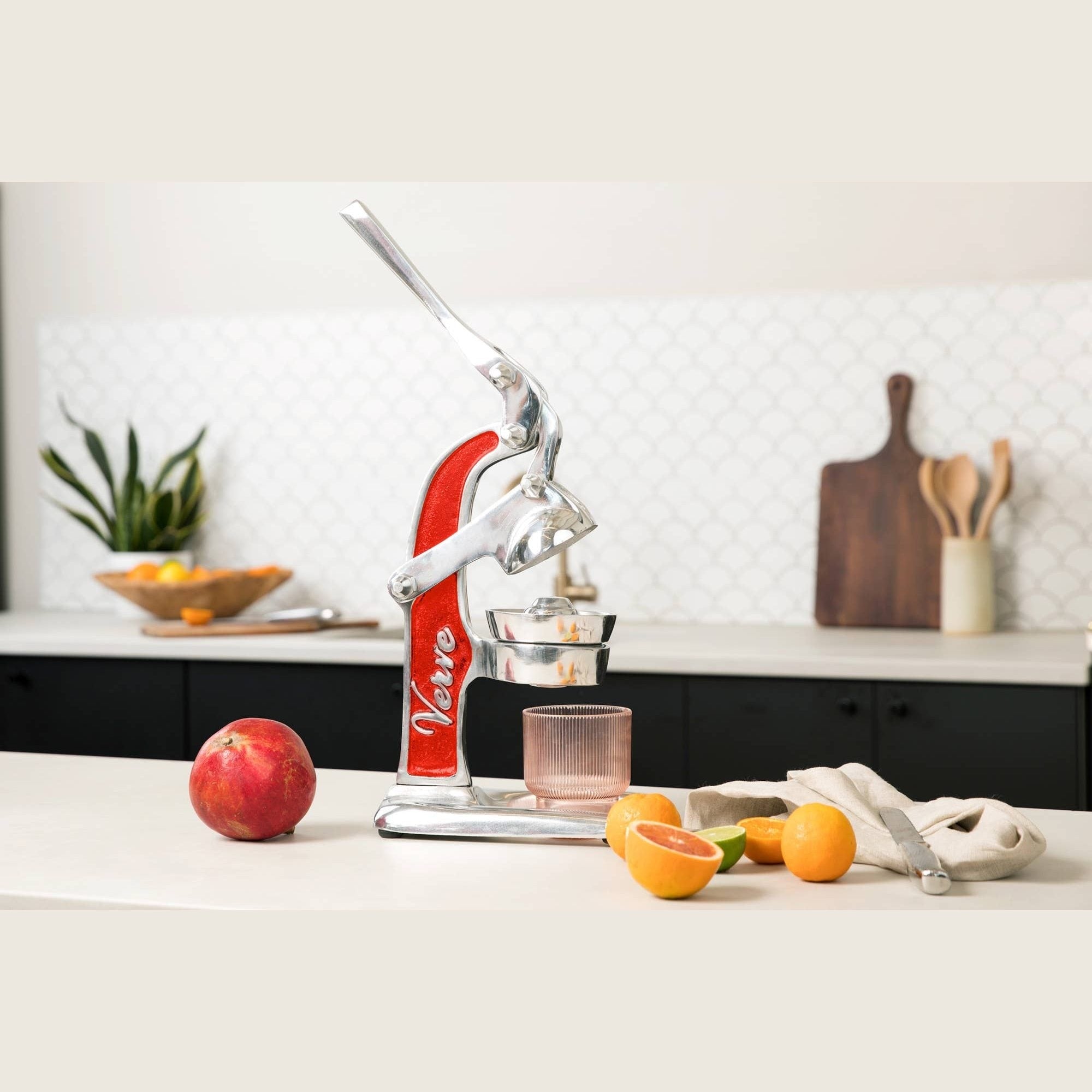 Green Mexican citrus juicer by Verve Culture with a sturdy handle and ridged cone for fresh juice extraction.