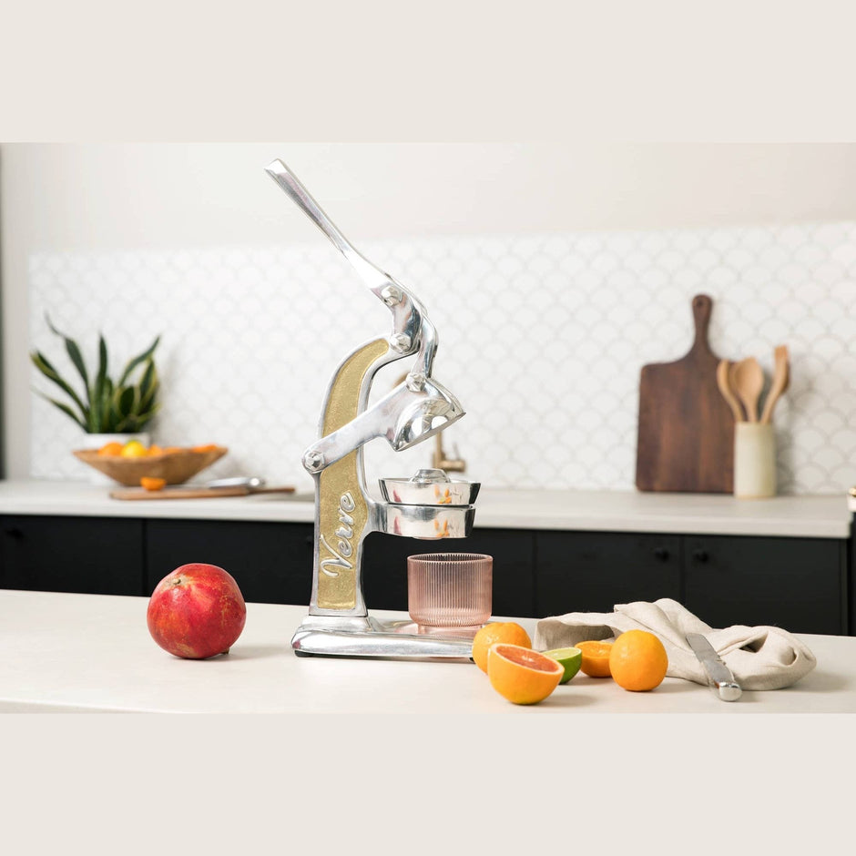 Green Mexican citrus juicer by Verve Culture, featuring a traditional manual design for fresh orange, lime, and lemon juice extraction.