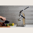 Green Mexican citrus juicer by Verve Culture with a sturdy handle and ridged reamer for fresh juice extraction.