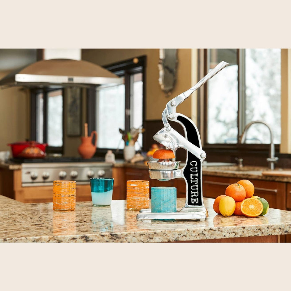 Green Mexican Citrus Juicer by Verve Culture, showcasing a traditional handheld juicer for fresh citrus fruit.