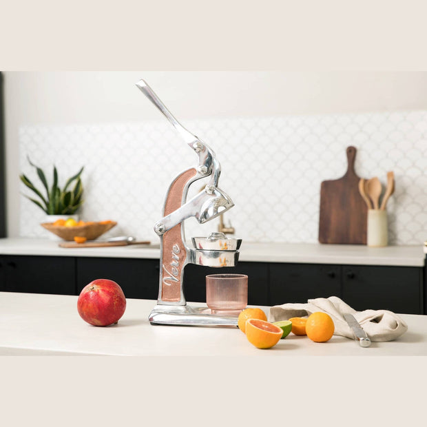 Green Mexican citrus juicer by Verve Culture, showcasing a handheld juicer for fresh citrus juice extraction.