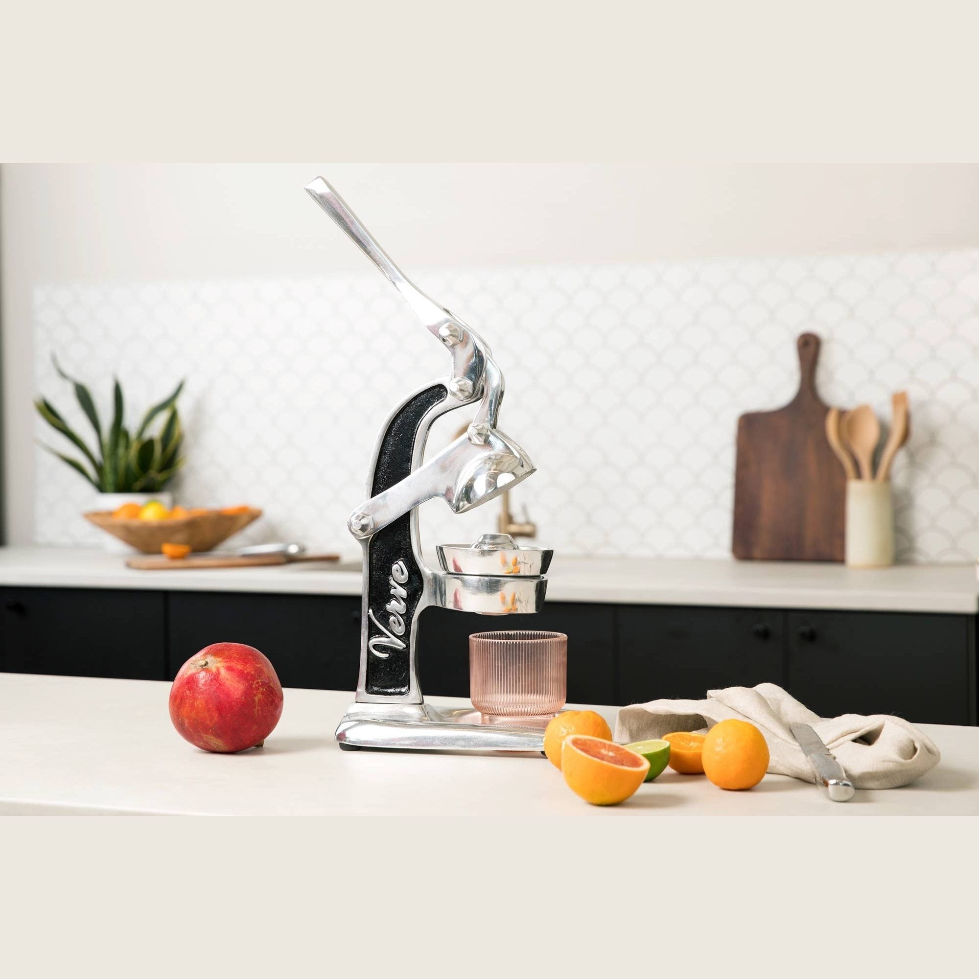Green Mexican citrus juicer by Verve Culture, showcasing a traditional hand-held juicer for fresh fruit extraction.