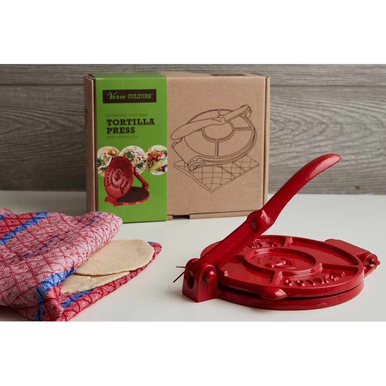 Cast iron tortilla press from Verve Culture with wooden handles and included tortilla-making accessories.