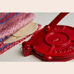 Cast iron tortilla press by Verve Culture with wooden handles and included tortilla maker accessories.