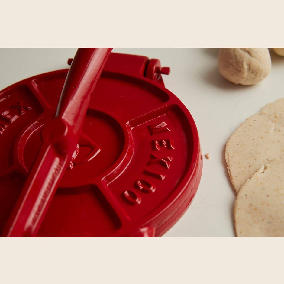 Cast iron tortilla press from Verve Culture with wooden handles, part of the tortilla press kit for authentic Mexican tortillas.