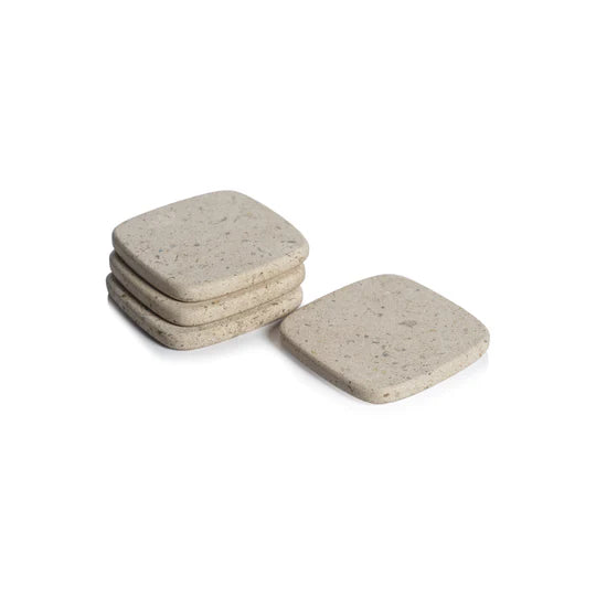 Set of four Zodax travertine marble coasters for bar accessories, featuring natural stone patterns and a sleek, stylish design.