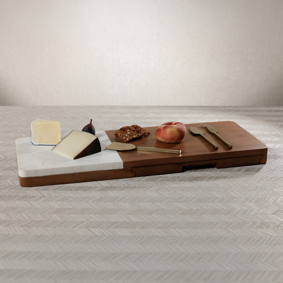 Marble and mango wood cheese and cutting board with tools, perfect for serving charcuterie and appetizers.
